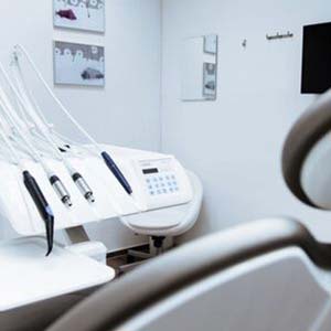 Modern dental treatment room and a dental unit featuring hand pieces and control panel